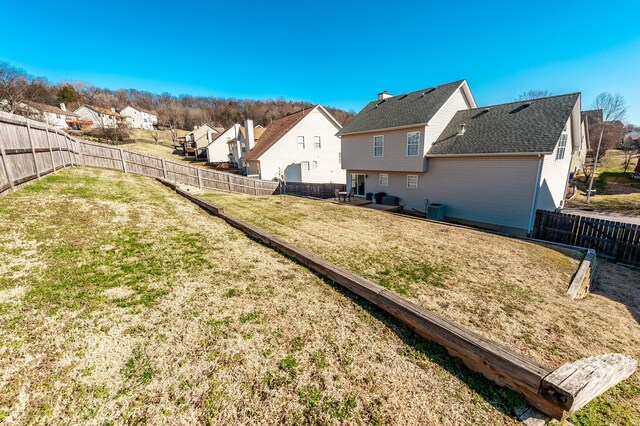 view of yard with a fenced backyard and a residential view