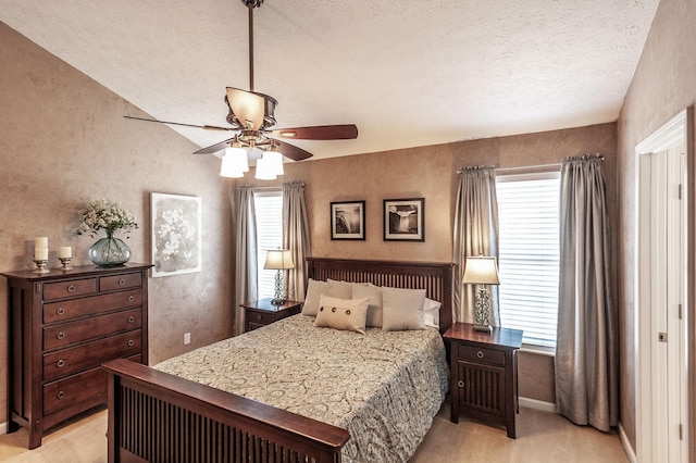 bedroom featuring multiple windows, light colored carpet, and a textured ceiling