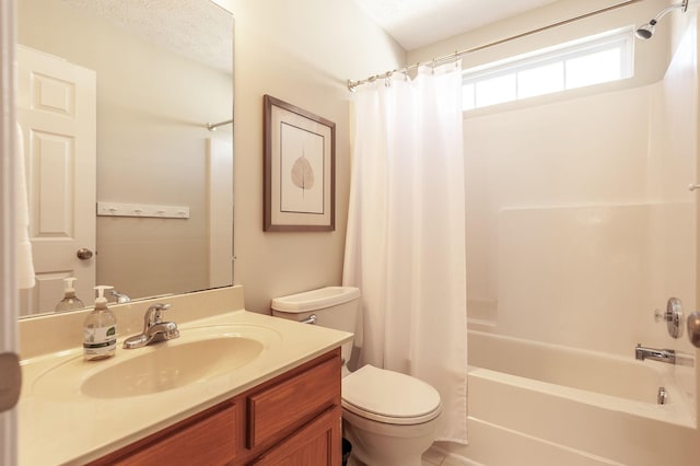 full bath with vanity, toilet, shower / bath combo, and a textured ceiling