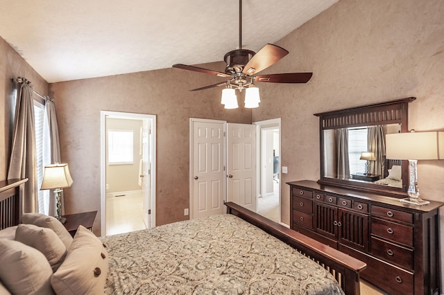 bedroom with lofted ceiling, ceiling fan, and ensuite bathroom