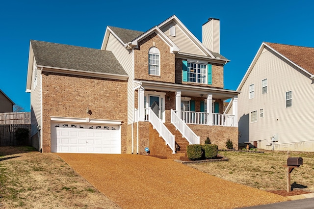 view of front of house with brick siding, covered porch, concrete driveway, and a chimney