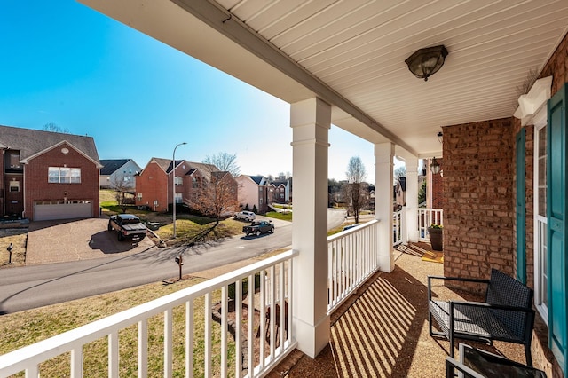 balcony featuring a residential view and covered porch