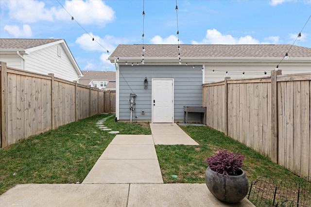 rear view of property with a yard and a fenced backyard