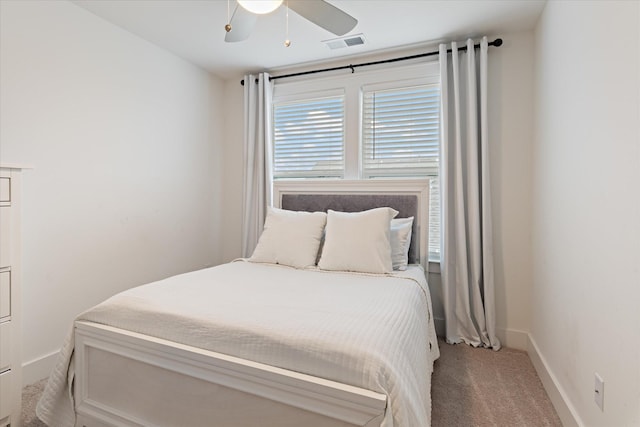 bedroom featuring visible vents, baseboards, carpet, and a ceiling fan