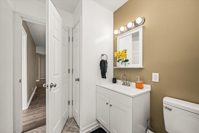 11216 Clay County Hwy, Moss, TN 38575 - bathroom featuring toilet, vanity, and baseboards