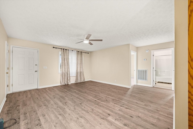 11216 Clay County Hwy, Moss, TN 38575 - unfurnished living room with visible vents, baseboards, a textured ceiling, and wood finished floors