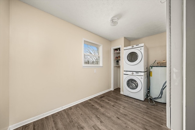 11216 Clay County Hwy, Moss, TN 38575 - clothes washing area with baseboards, laundry area, stacked washing maching and dryer, wood finished floors, and a textured ceiling