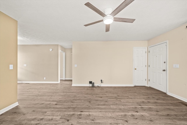 11216 Clay County Hwy, Moss, TN 38575 - empty room with ceiling fan, wood finished floors, baseboards, and a textured ceiling