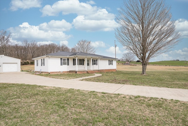 11216 Clay County Hwy, Moss, TN 38575 - view of front facade with an outbuilding, a front yard, covered porch, a garage, and metal roof