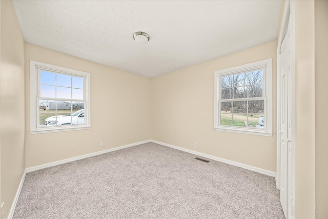 11216 Clay County Hwy, Moss, TN 38575 - spare room with visible vents, carpet floors, a textured ceiling, and baseboards