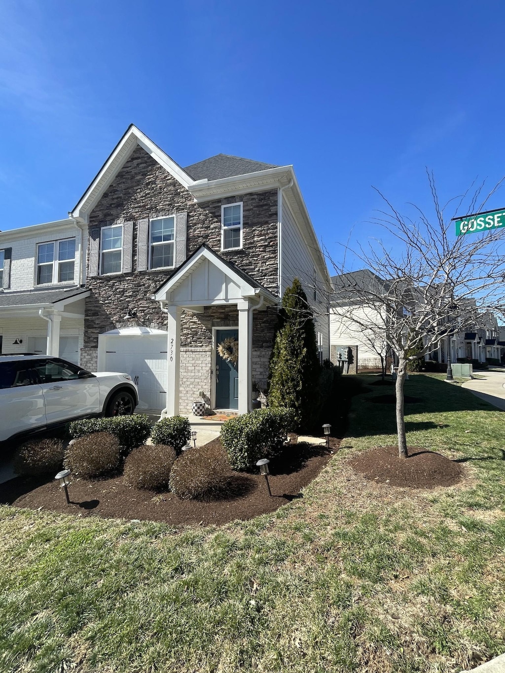 view of front of property with stone siding and a front yard