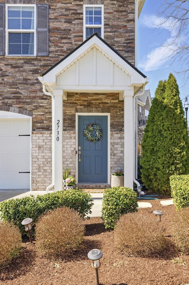 doorway to property with a garage