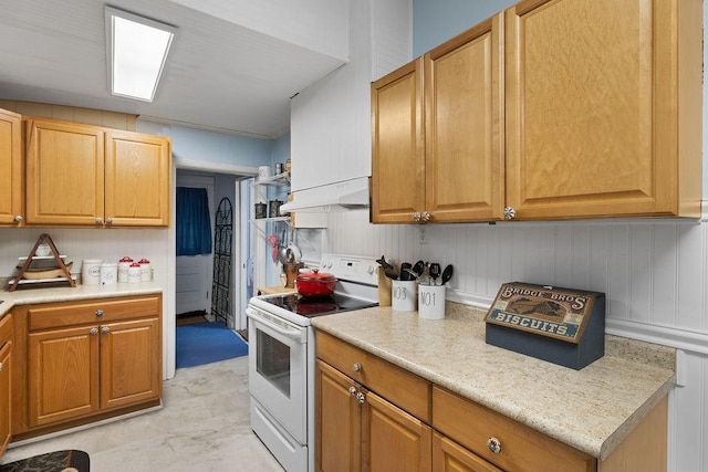 kitchen with under cabinet range hood, light countertops, and electric stove