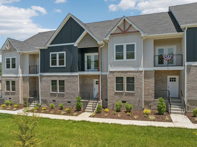 multi unit property with crawl space, board and batten siding, a shingled roof, and brick siding