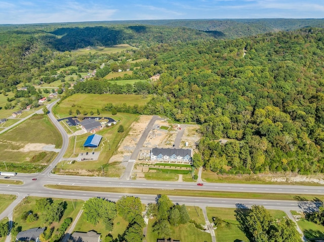 drone / aerial view featuring a forest view