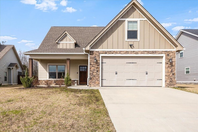 craftsman inspired home featuring a front yard, driveway, roof with shingles, stone siding, and board and batten siding