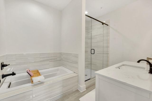 full bath featuring a stall shower, a garden tub, and a sink