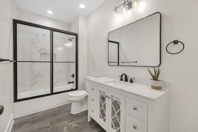 full bathroom featuring vanity, toilet, recessed lighting, and combined bath / shower with glass door