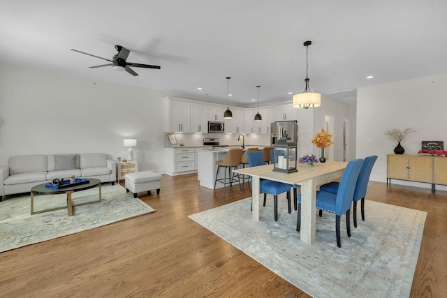 dining space with recessed lighting, baseboards, wood finished floors, and ceiling fan