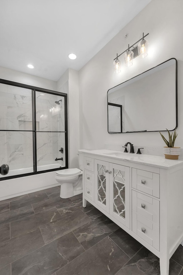 bathroom with toilet, recessed lighting, combined bath / shower with glass door, marble finish floor, and vanity