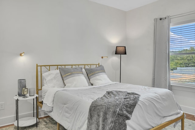 bedroom with wood finished floors and baseboards