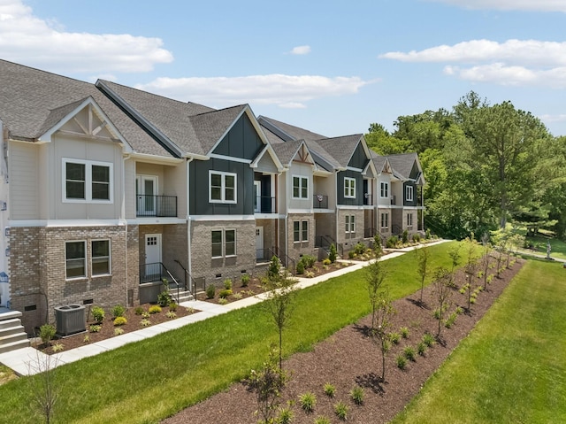 view of front of home featuring central air condition unit, a front lawn, a residential view, crawl space, and brick siding