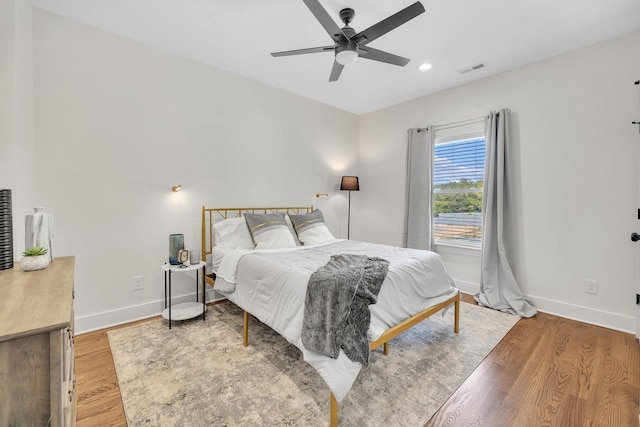 bedroom with recessed lighting, a ceiling fan, light wood-type flooring, and baseboards