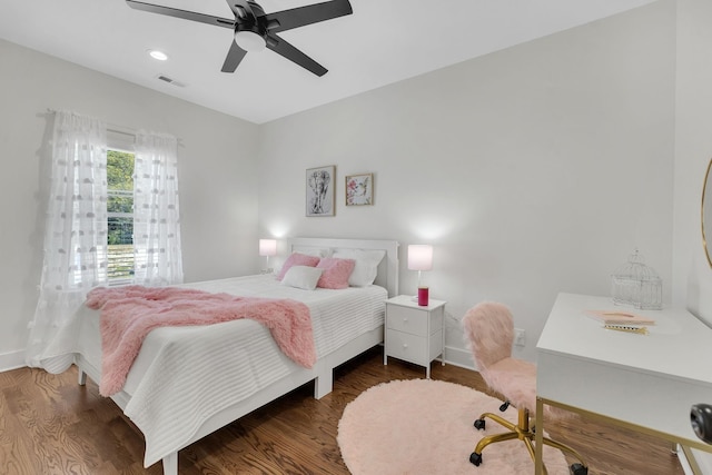 bedroom with visible vents, ceiling fan, baseboards, and wood finished floors