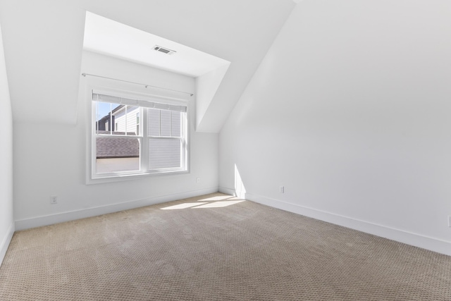 carpeted spare room featuring baseboards and visible vents