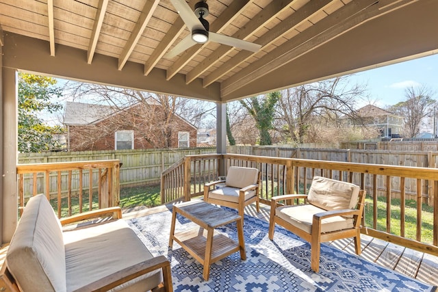 wooden deck featuring an outdoor hangout area, a fenced backyard, and ceiling fan