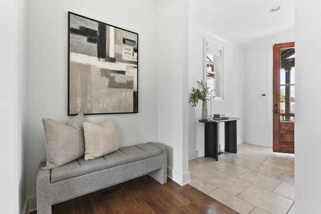 sitting room with light tile patterned floors, visible vents, and baseboards