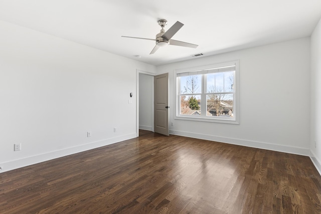 interior space with a ceiling fan, dark wood-type flooring, baseboards, and visible vents