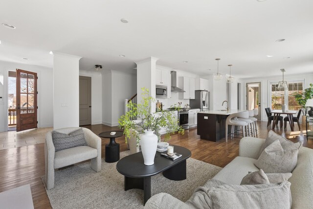 living room featuring baseboards, recessed lighting, stairs, dark wood-type flooring, and crown molding