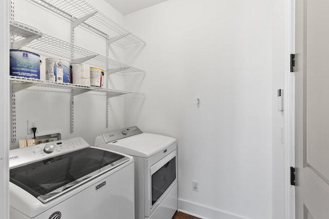 laundry room featuring laundry area, separate washer and dryer, and baseboards