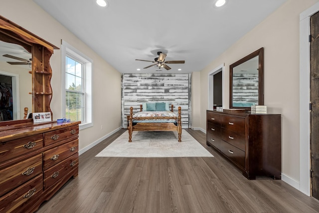 bedroom with recessed lighting, baseboards, and dark wood finished floors