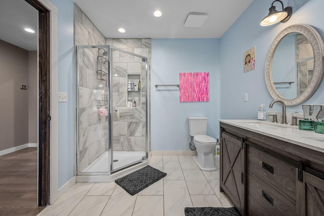 full bath with toilet, marble finish floor, a shower stall, baseboards, and vanity