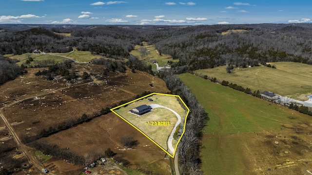 aerial view featuring a rural view and a wooded view