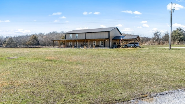 exterior space featuring an attached carport, a front yard, and metal roof