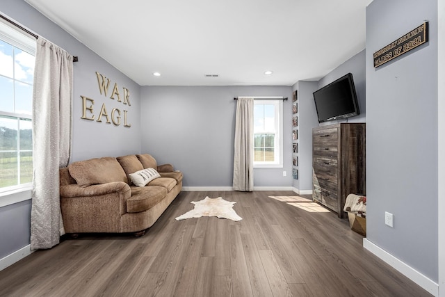 unfurnished living room featuring visible vents, recessed lighting, baseboards, and wood finished floors