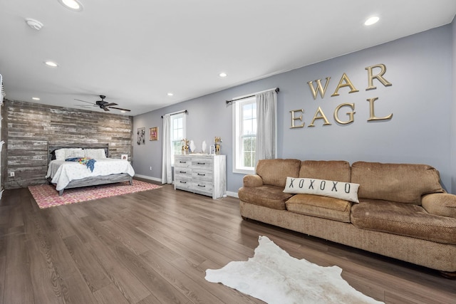 bedroom featuring a ceiling fan, wood finished floors, baseboards, recessed lighting, and a multi sided fireplace