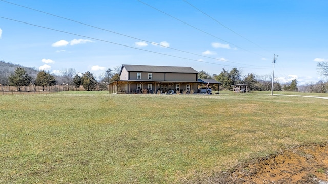 exterior space featuring a yard, a carport, and a porch