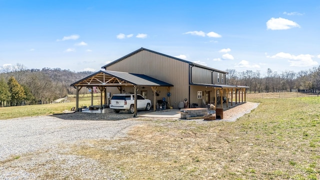 exterior space with a carport, a lawn, and driveway