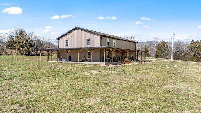 back of house with a lawn and a patio