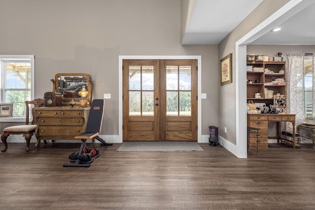 entryway featuring french doors, baseboards, and wood finished floors