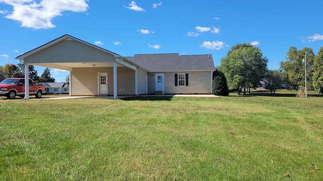 view of front facade with an attached carport and a front yard