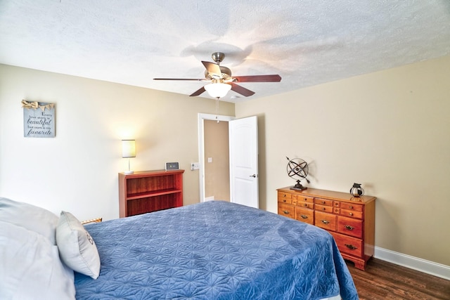 bedroom with baseboards, a textured ceiling, dark wood-style floors, and a ceiling fan