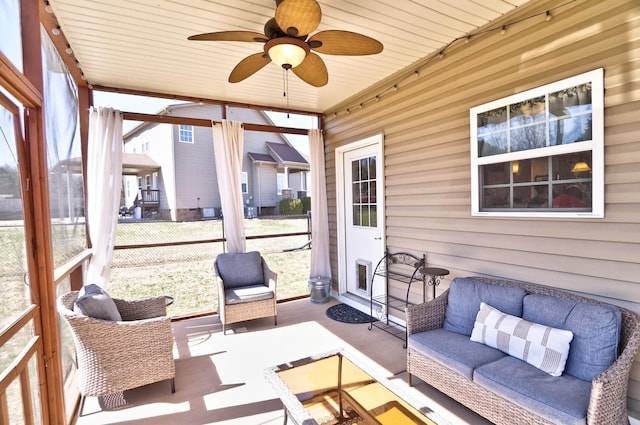 sunroom with a ceiling fan