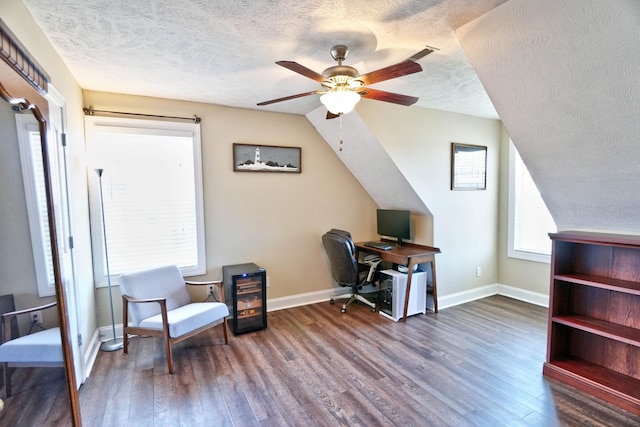 office space featuring a textured ceiling, baseboards, a ceiling fan, and wood finished floors