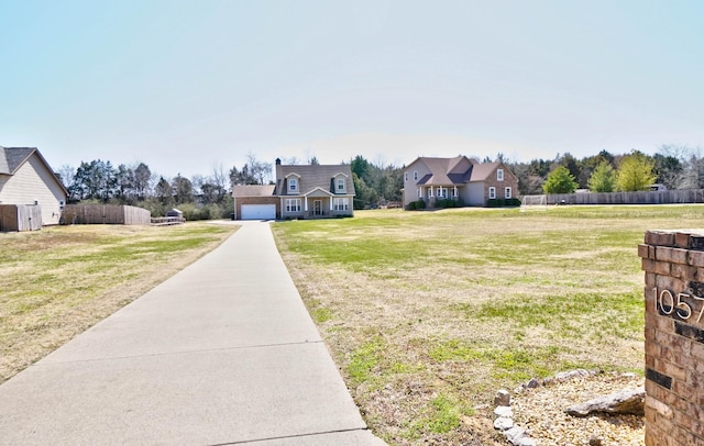 view of yard with fence and a garage