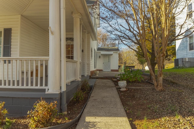 view of side of home featuring covered porch